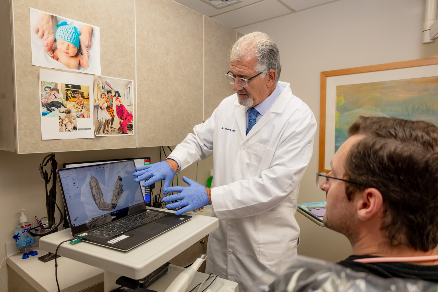 Dentist showing dental X-ray and explaining the findings to a patient.