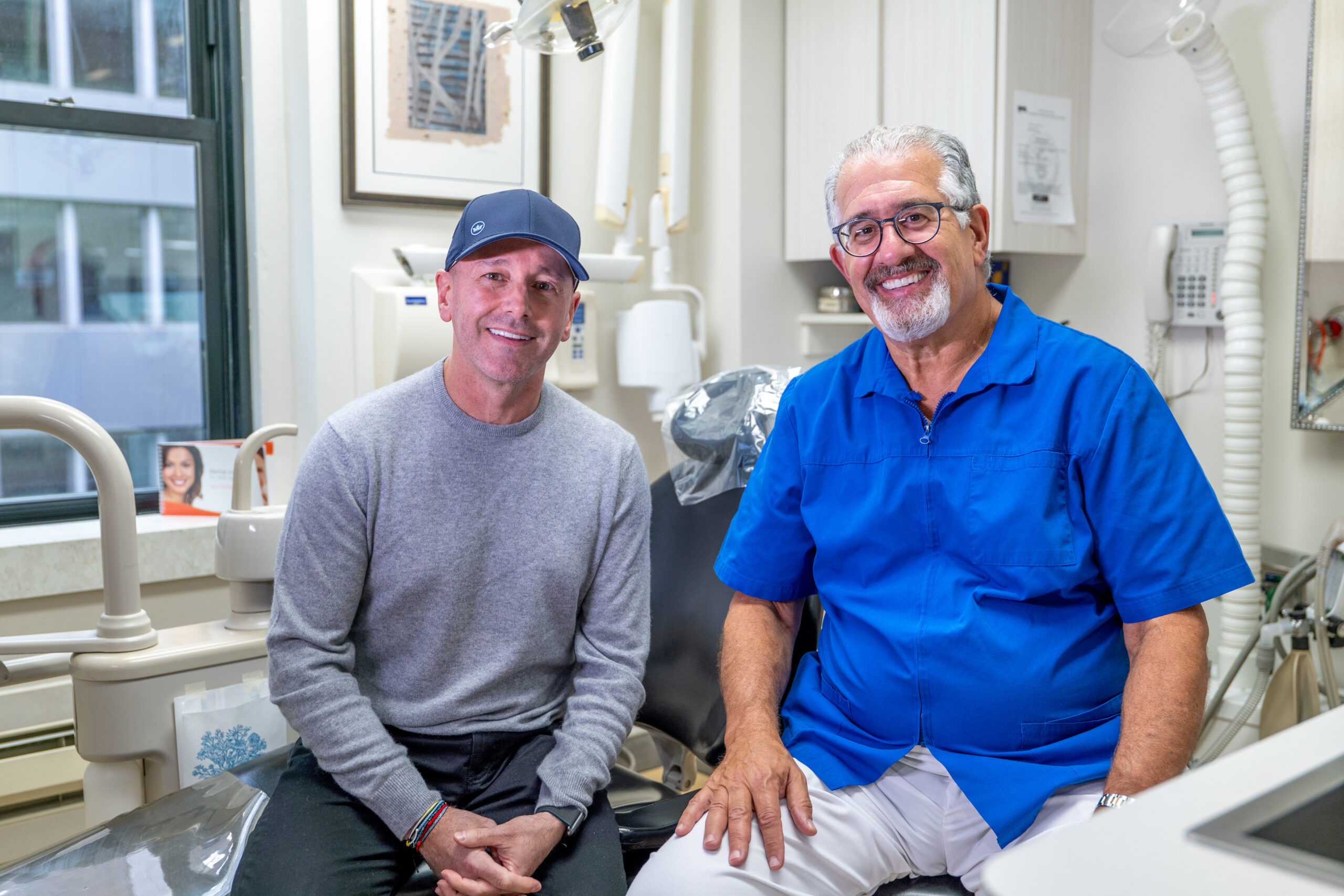 Dr. Michael Sinkin talking with a patient at his Midtown Manhattan dental practice.