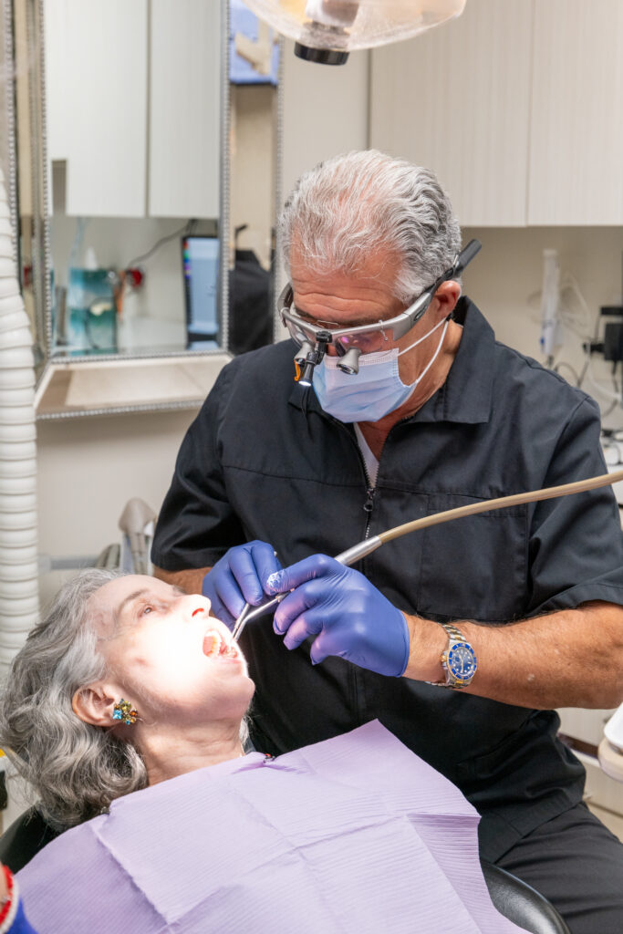 Dr. Michael Sinkin performing a dental cleaning and exam at his Midtown Manhattan dental office