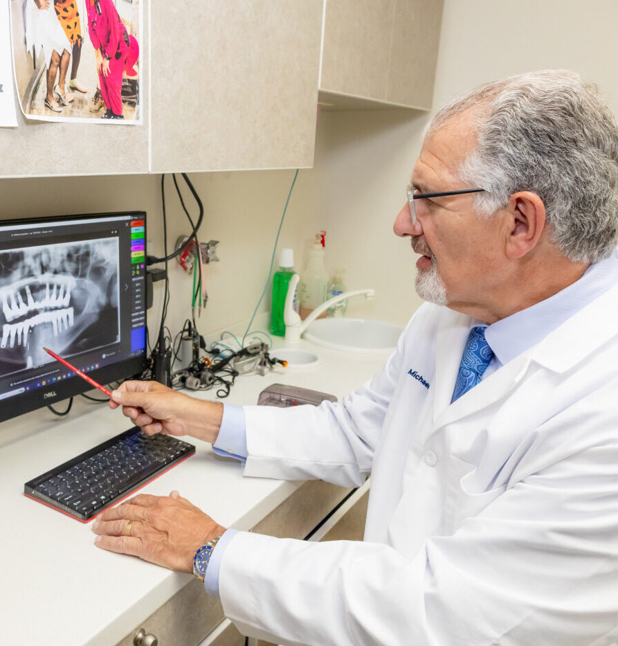 Dentist and patient reviewing All-On-4 and All-On-X implant treatment plan in New York City