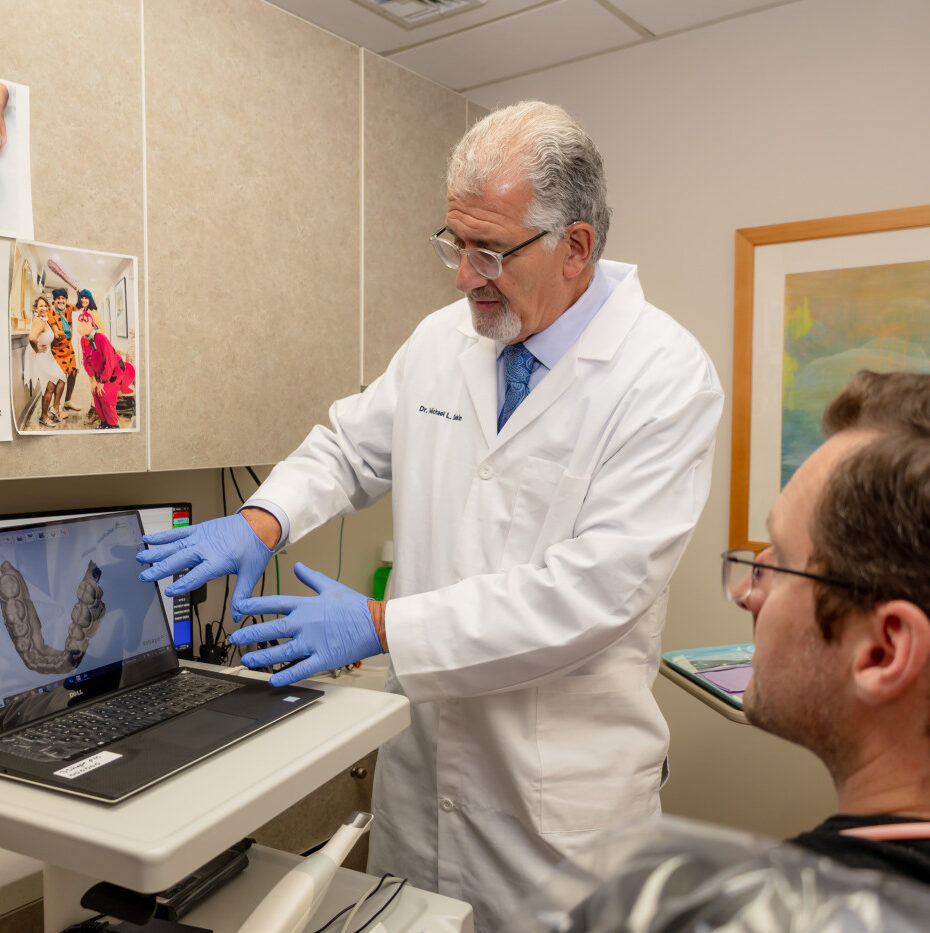 Dentist reviewing a dental image with a patient during a bone grafting consultation in a Manhattan dental office