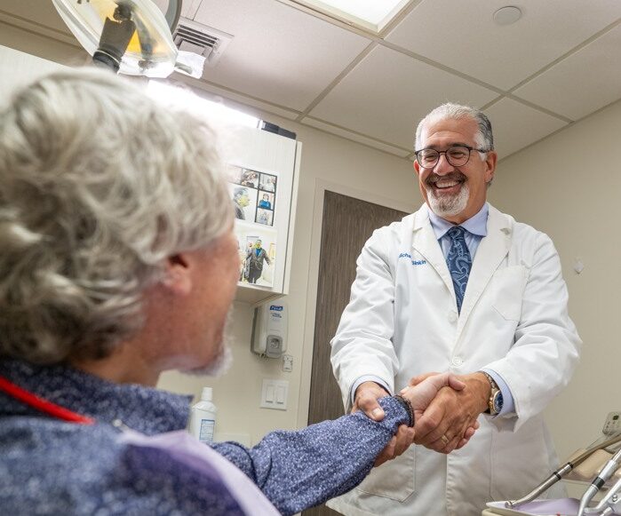 Dentist in Midtown Manhattan discussing implant supported crowns and bridges with a patient