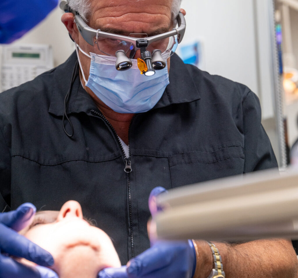 Dentist performing a bite and occlusal analysis to identify the cause of jaw or tooth pain