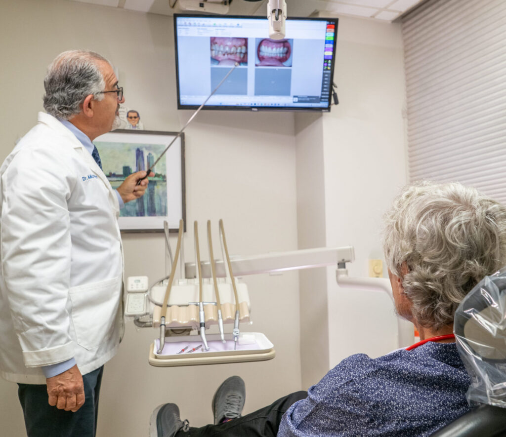 Dr. Michael Sinkin reviewing a complex dental treatment plan with a patient in his Midtown Manhattan office