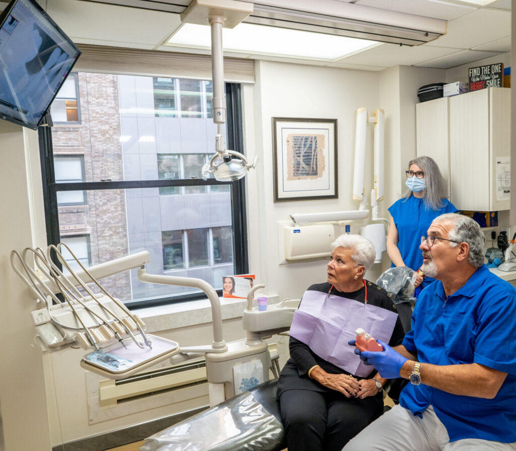 Dr Sinkin and his patient reviewing xrays in his Midtown Manhattan dental office